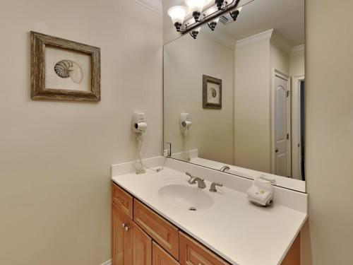 a bathroom with a sink and a mirror at Adagio 301e in Santa Rosa Beach