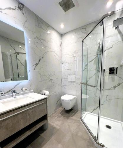 a bathroom with a sink and a shower and a toilet at Stunning Ventura Condo in Orlando
