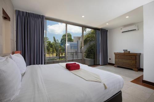 - une chambre avec un grand lit et une grande fenêtre dans l'établissement Modern 3BR Pool Access Villa Argent 6, à Ban Muang Mai