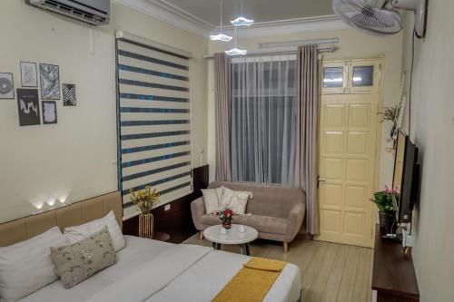 a hotel room with a bed and a chair at Hanoi Family Homestay in Hanoi