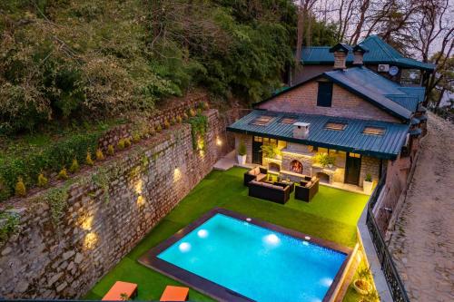 an aerial view of a house with a swimming pool at StayVista at Paris Villa with Pvt Pool & Valley View in Kasauli