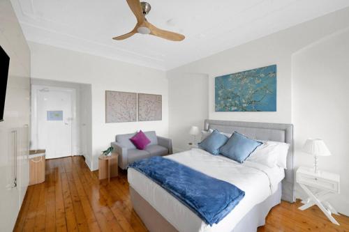 a bedroom with a bed and a ceiling fan at Kadina Harbourside Studio - A Cosy Panoramic Gem in Sydney