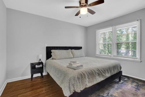 a bedroom with a bed and a ceiling fan at Cozy Home In Forest Park, GA in Forest Park