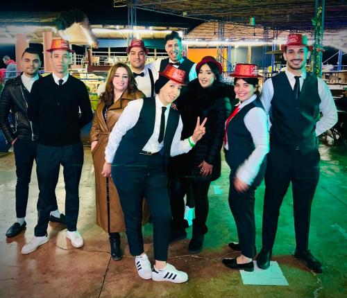 a group of people dressed in red hats posing for a picture at maison d'hôtes yamine in Beni Mellal