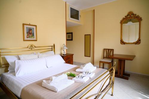 a bedroom with a large bed with towels on it at Relaxing House in Lido di Ostia