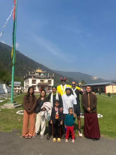 a group of people are posing for a picture at Pema Dekey monastic guest house in Dirang Dzong