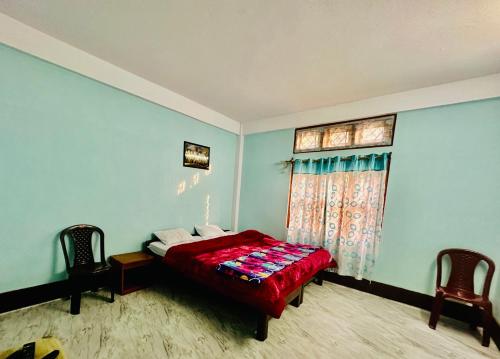a bedroom with a bed and a window at Pema Dekey monastic guest house in Dirang Dzong