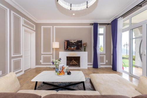 a living room with a couch and a fireplace at Biệt Thự Đà Lạt View Đẹp - Gần Chợ Đêm in Xuan An