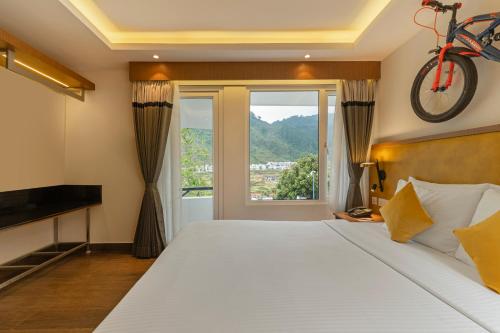 a bedroom with a bed with a bicycle on the wall at Sterling Kodai Valley in Kodaikānāl