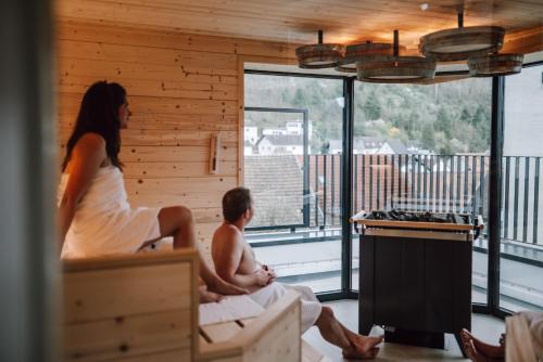 a man and a woman sitting in a cabin at Schmidtburger Hof in Weiler