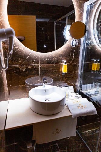 a bathroom with a sink and a large mirror at Hotel Boka in Kotor