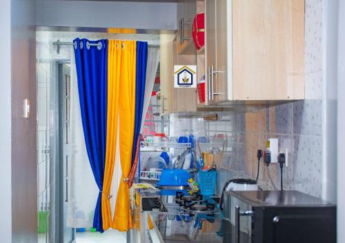 a kitchen with colorful curtains in a room at Othaya Hideout in Othaya