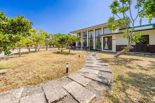 a stone path in front of a building at Southern Sun Homestay North in Kenting