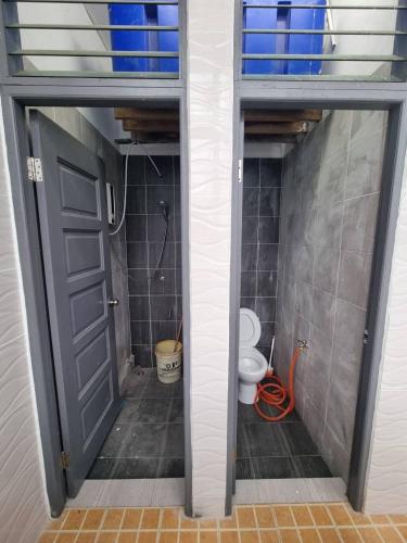 łazienka z toaletą i otwartymi drzwiami w obiekcie Happy Living w mieście Sibu