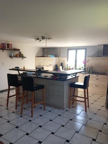 a kitchen with a table and chairs in it at Chez Nath in Aubréville