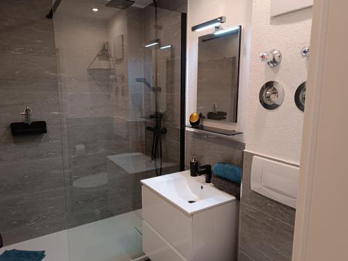 a bathroom with a white sink and a shower at Alpenpanorama in Fischen