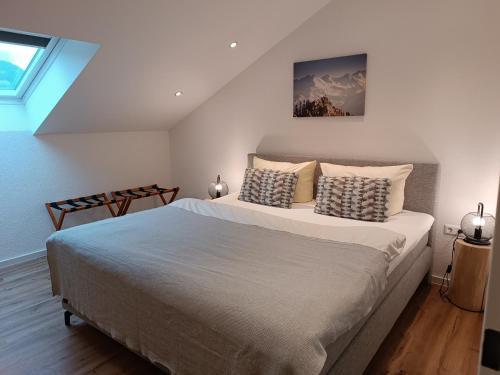 a bedroom with a large bed and a window at Alpenpanorama in Fischen