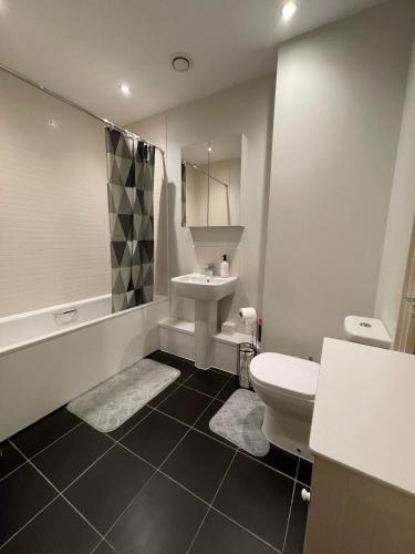 a bathroom with a toilet and a sink at Peaceful shared flat 30mins Central London in Colindale