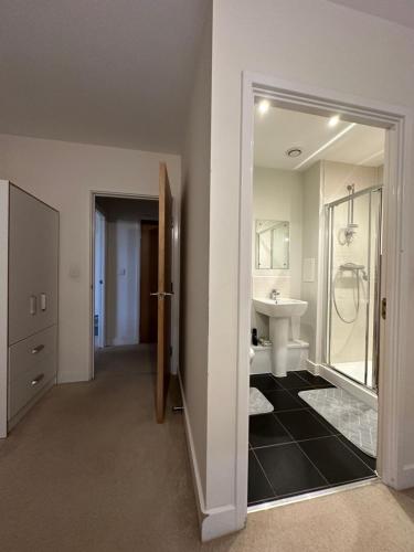 a bathroom with a sink and a toilet and a mirror at Peaceful shared flat 30mins Central London in Colindale