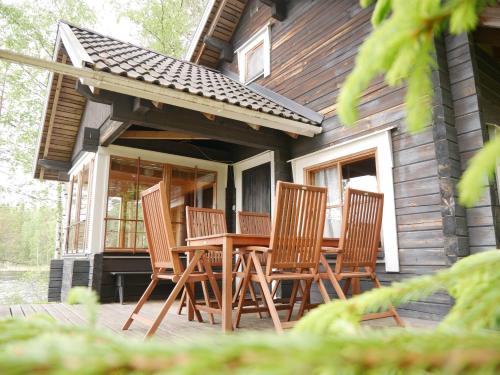 a group of chairs sitting on the porch of a cabin at Mökki Aapola in Puumala