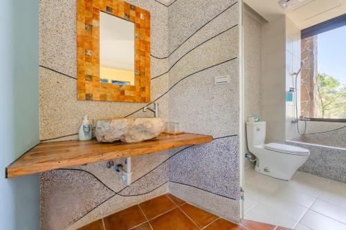 a bathroom with a sink and a toilet at Southern Sun Homestay North in Kenting
