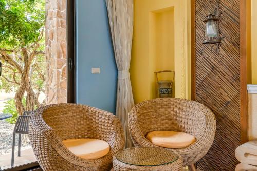 two wicker chairs sitting next to a window at Southern Sun Homestay North in Kenting