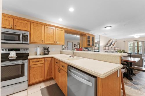 a kitchen with wooden cabinets and a counter top at Dog-Friendly Quiet Cove Condo in Hollister