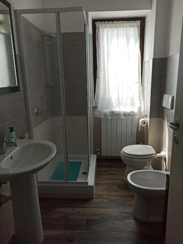 a bathroom with a shower and a toilet and a sink at B&BEES in Rocca Ranieri