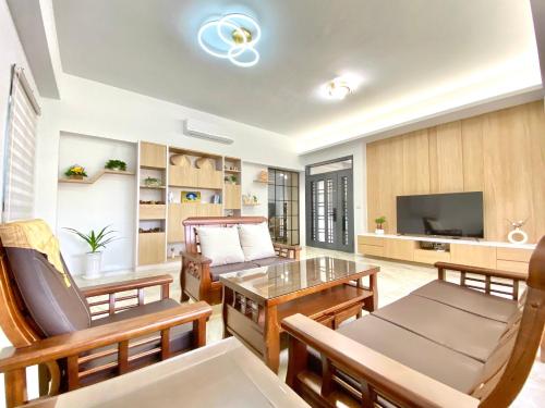 a living room with wooden furniture and a television at 隱 the house in Magong