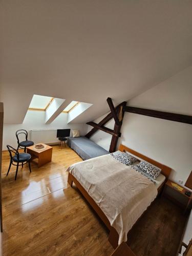 a bedroom with a bed in a room with skylights at Penzion Podzámčí in Jaroslavice