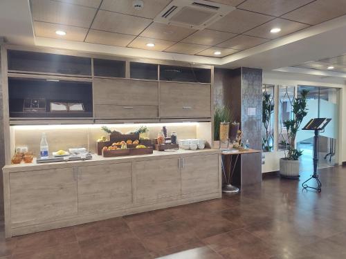 a large kitchen with a counter with food on it at Hotel Sercotel Cuatro Postes in Avila