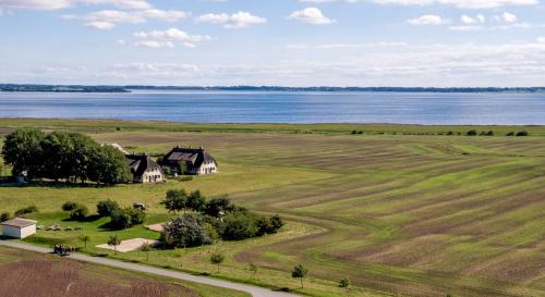 an aerial view of a farm and the water at Rügen-Ferienhof in Ummanz
