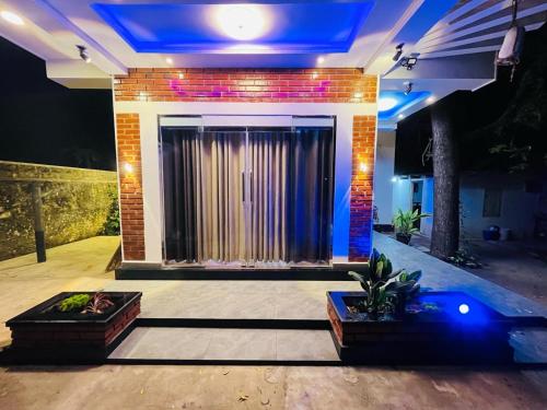 a living room with a large screen in front of a building at Neems paradise in Point Pedro