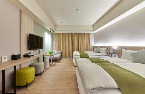a hotel room with two beds and a television at Aspire Resort in Longtan