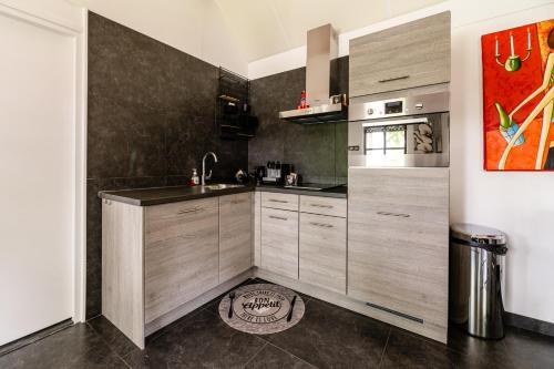 a kitchen with a sink and a counter top at Brabants Genieten in Kaatsheuvel