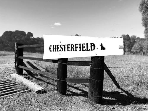 a sign that says checked on a fence at Chesterfield Farm Stay - Private Room in Barlil