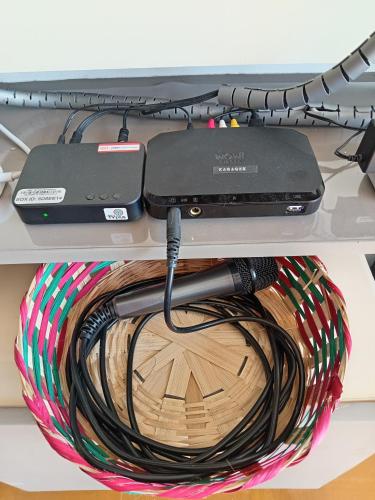 a laptop and a charger on a shelf at De Leon Staycation at Vista de Loro in Ternate