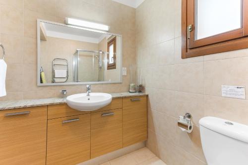 a bathroom with a sink and a mirror at 2 bedroom Apartment Asulon with communal pools, Aphrodite Hills Resort in Kouklia