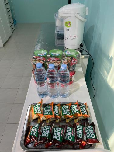 a refrigerator filled with bottles of water and snacks at NUN GUEST HOUSE in Ban Bo Han