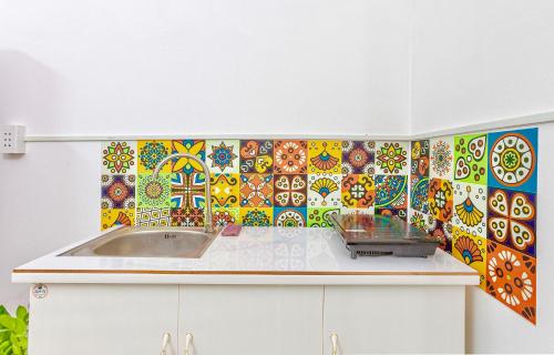 a kitchen with a sink and a colorful tile wall at Feli Home 1 - Close to Landmark 81 in Ho Chi Minh City