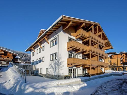 a large building with snow in front of it at Modern Apartment near Ski Area in Brixen im Thale in Feuring