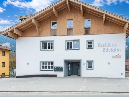 a large white building with a wooden roof at Luxury penthouse with Balcony Ski Storage Carport Lift in Brixen im Thale