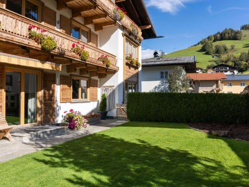 a house with a yard with green grass at Scenic Apartment in Maria Alm near Ski Lift in Maria Alm am Steinernen Meer