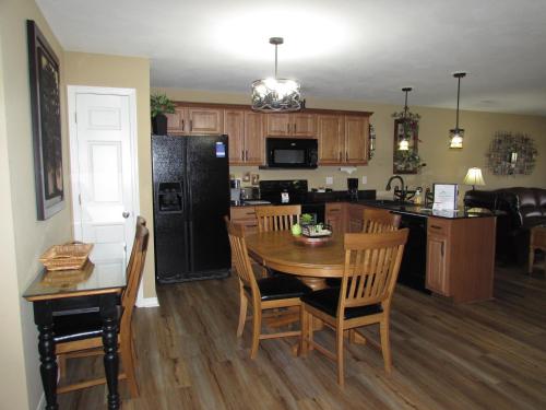 a kitchen with a table and a black refrigerator at Lakefront Condo A-3 in Hollister