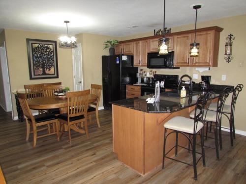 an open kitchen and dining room with a table and chairs at Lakefront Condo A-3 in Hollister