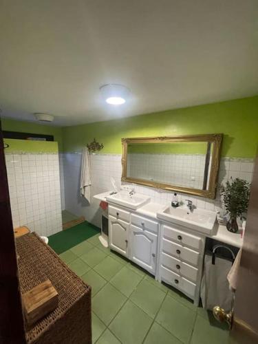 a bathroom with two sinks and a mirror at Art residency Lagoon in Seville