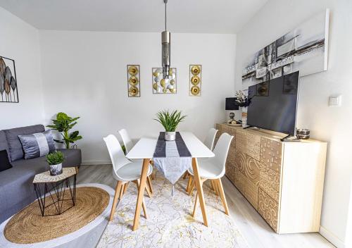 a living room with a table and a tv at Casa Sol e Areia /Villa Eira Nova in Porto Covo