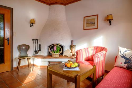 a living room with a couch and a table with a bowl of fruit at Waldpension Putz in Berg im Drautal