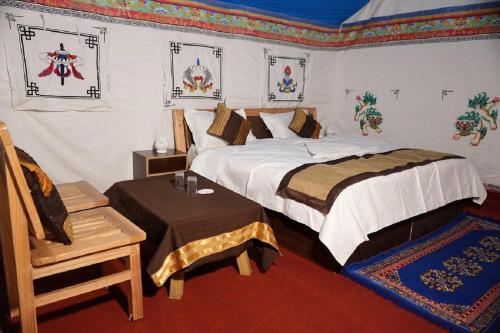 ein Schlafzimmer mit einem Bett und einem Stuhl darin in der Unterkunft Martsemik Camping & Resort Shachukul in Tangtse