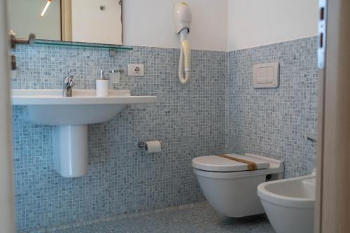 a bathroom with a sink and a toilet at Sikelika Residence Sul Mare in Scoglitti